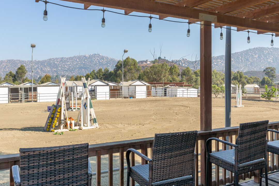 Outdoor arena with jumps, viewed from the covered deck
