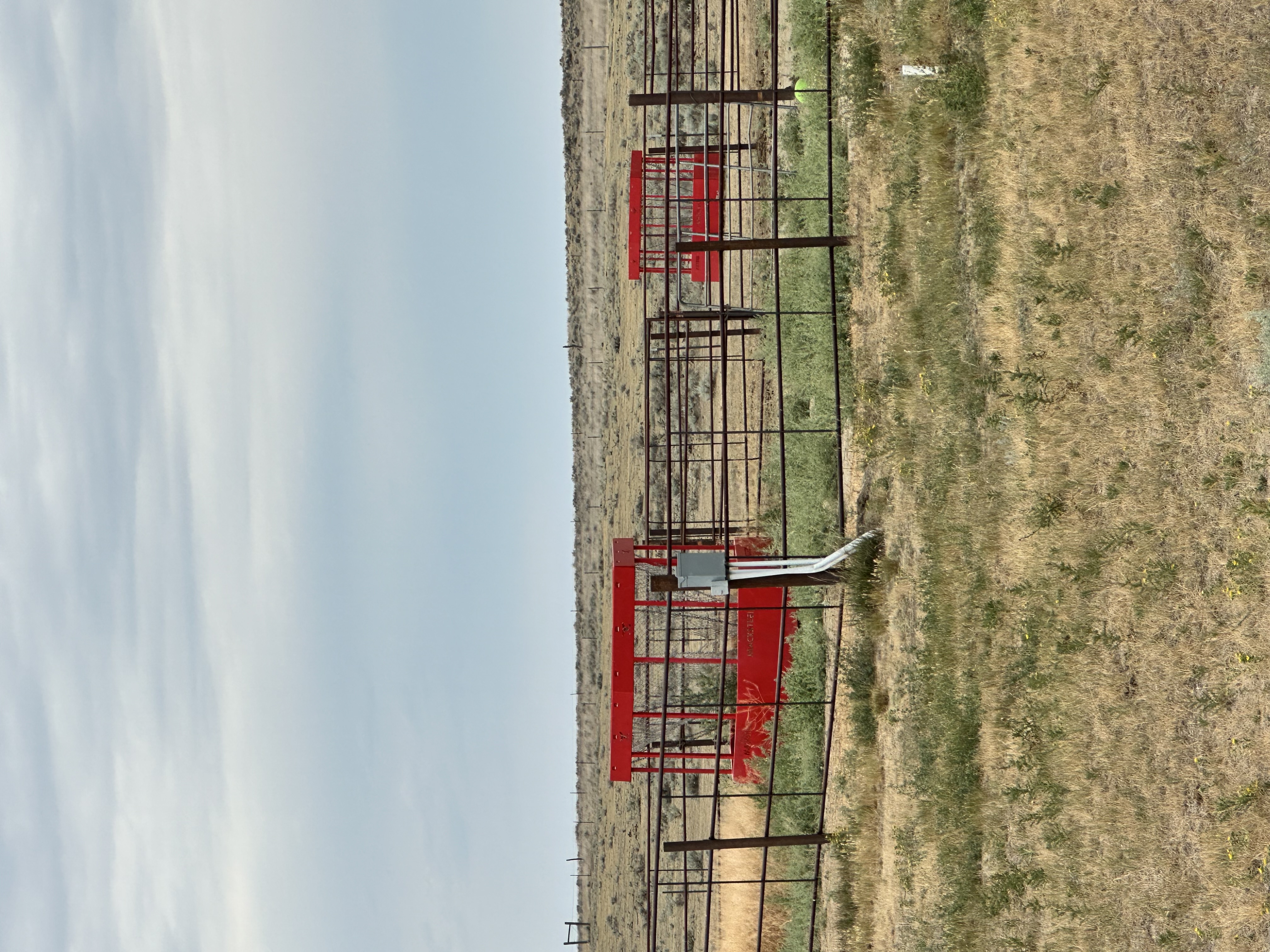 Pasture with large round bale feeders