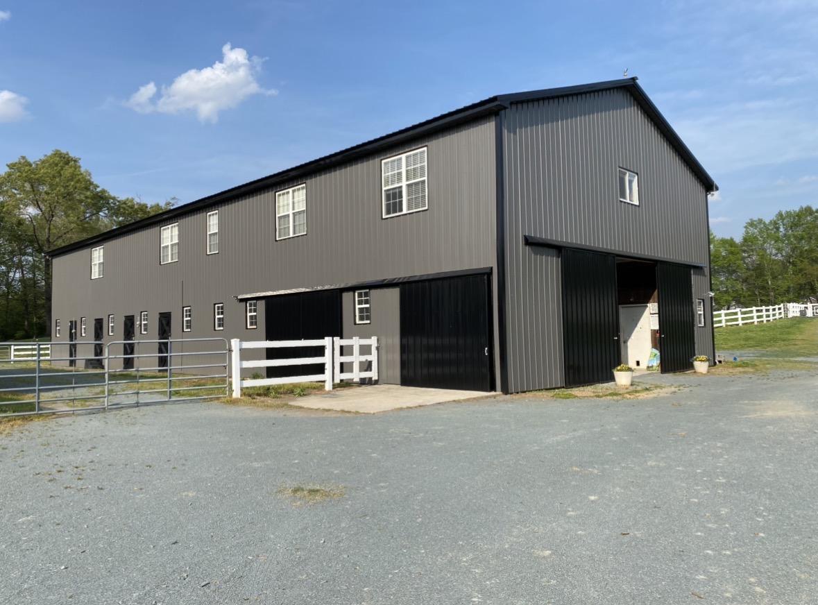 Beautiful main barn with 8 spacious stalls, 3 tack rooms, bathroom, wash bays, and feed room.