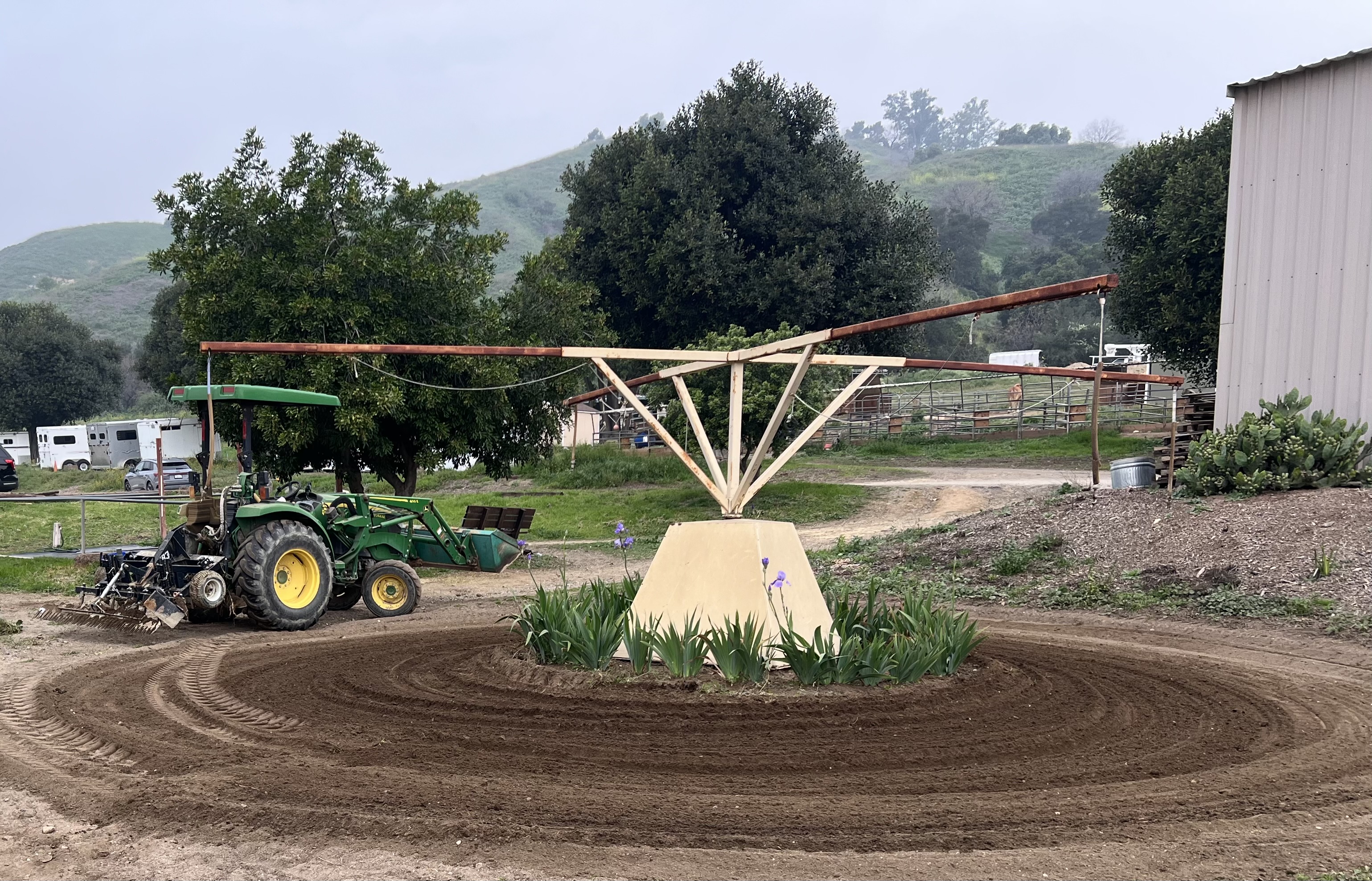 Keeping the footing on the hot walker nice and level for the horses